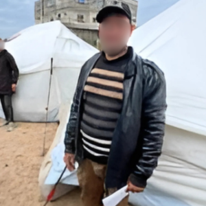 A man standing in the tents area - build a toilet appeal